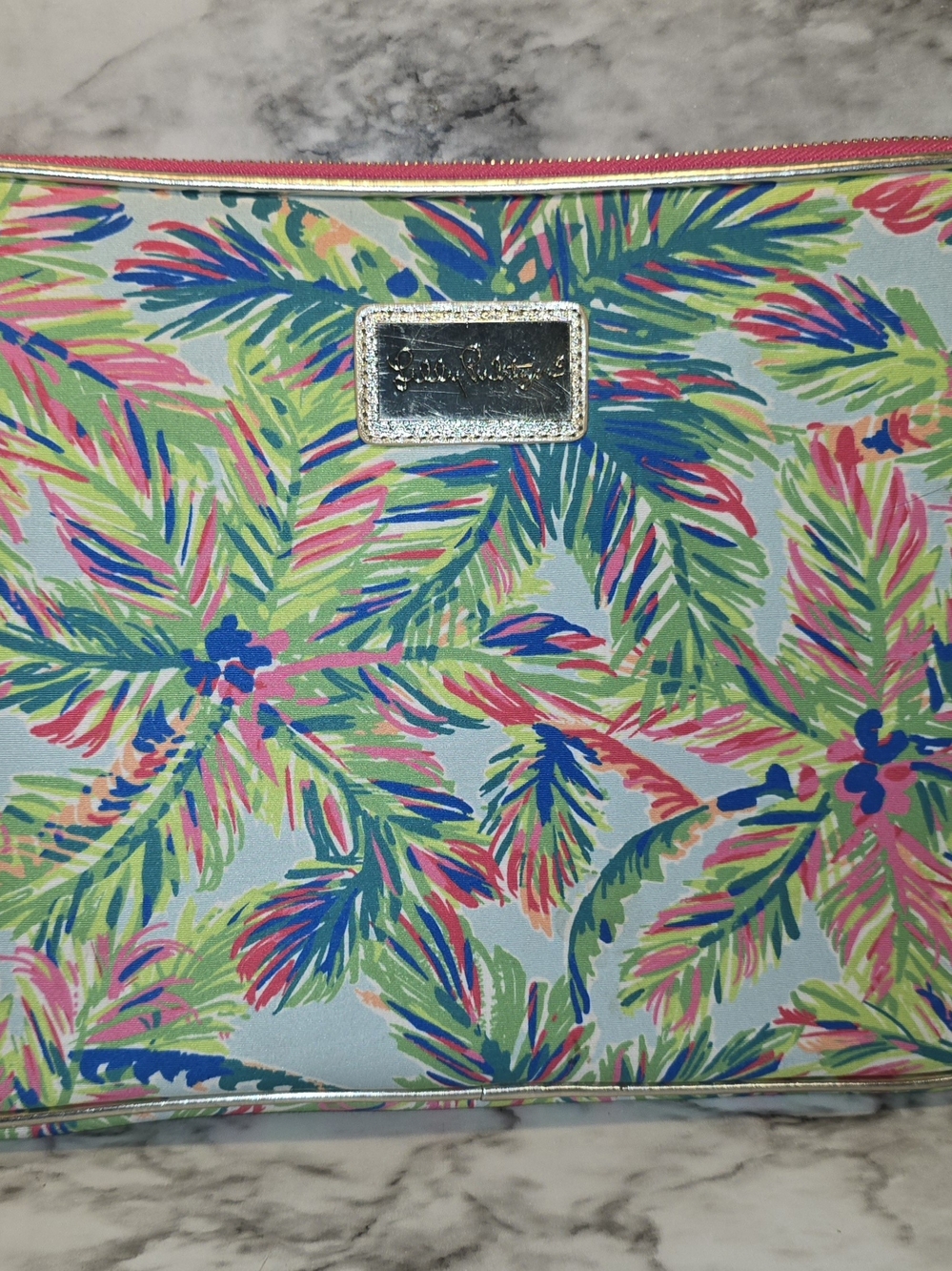 Lilly Pulitzer 13-inch laptop sleeve featuring a pink and green palm tree patter
